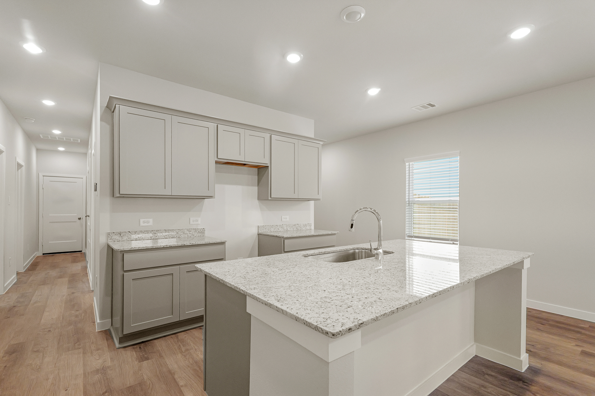 A kitchen with white cabinets.