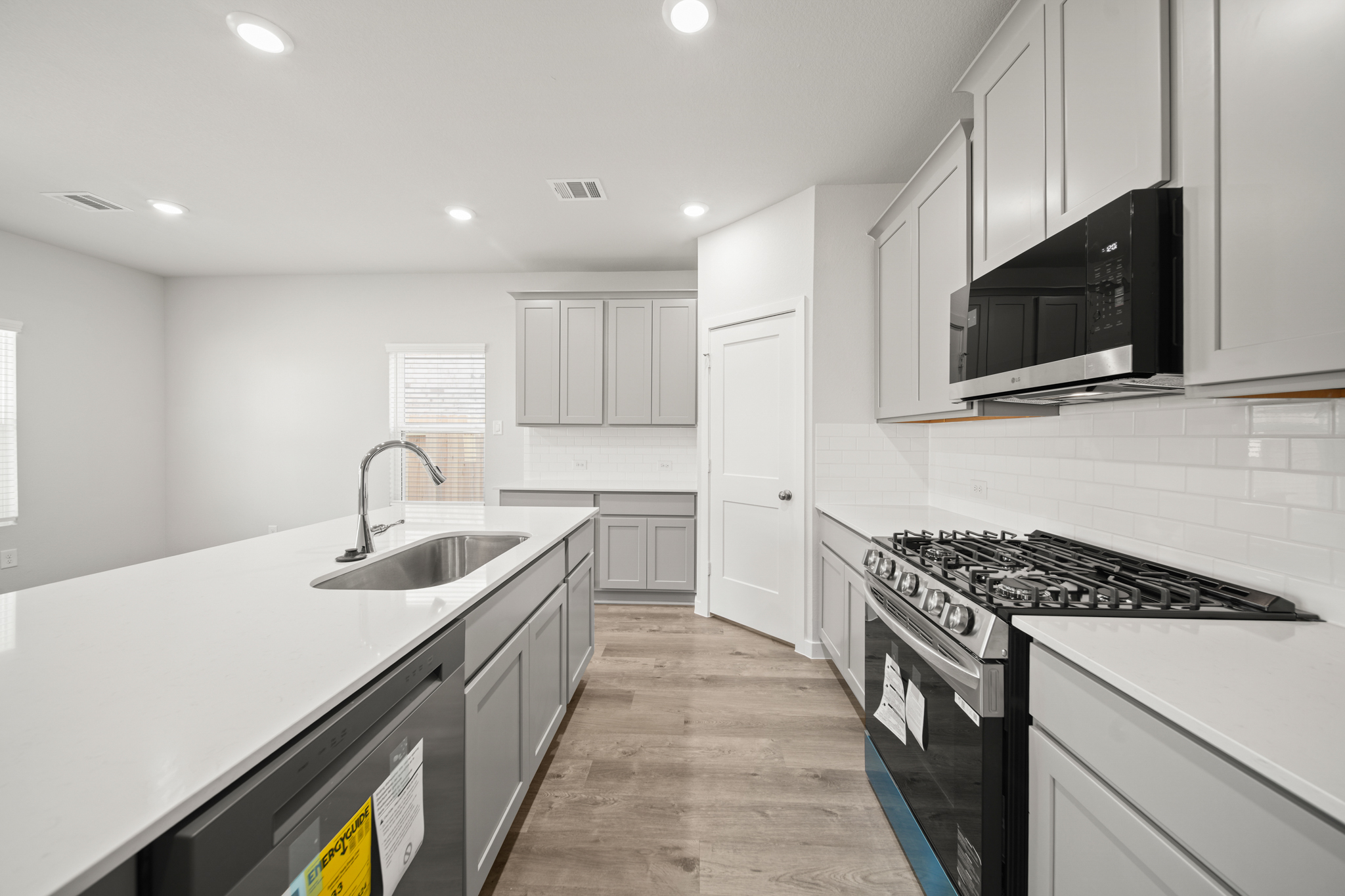 A kitchen with white cabinets.
