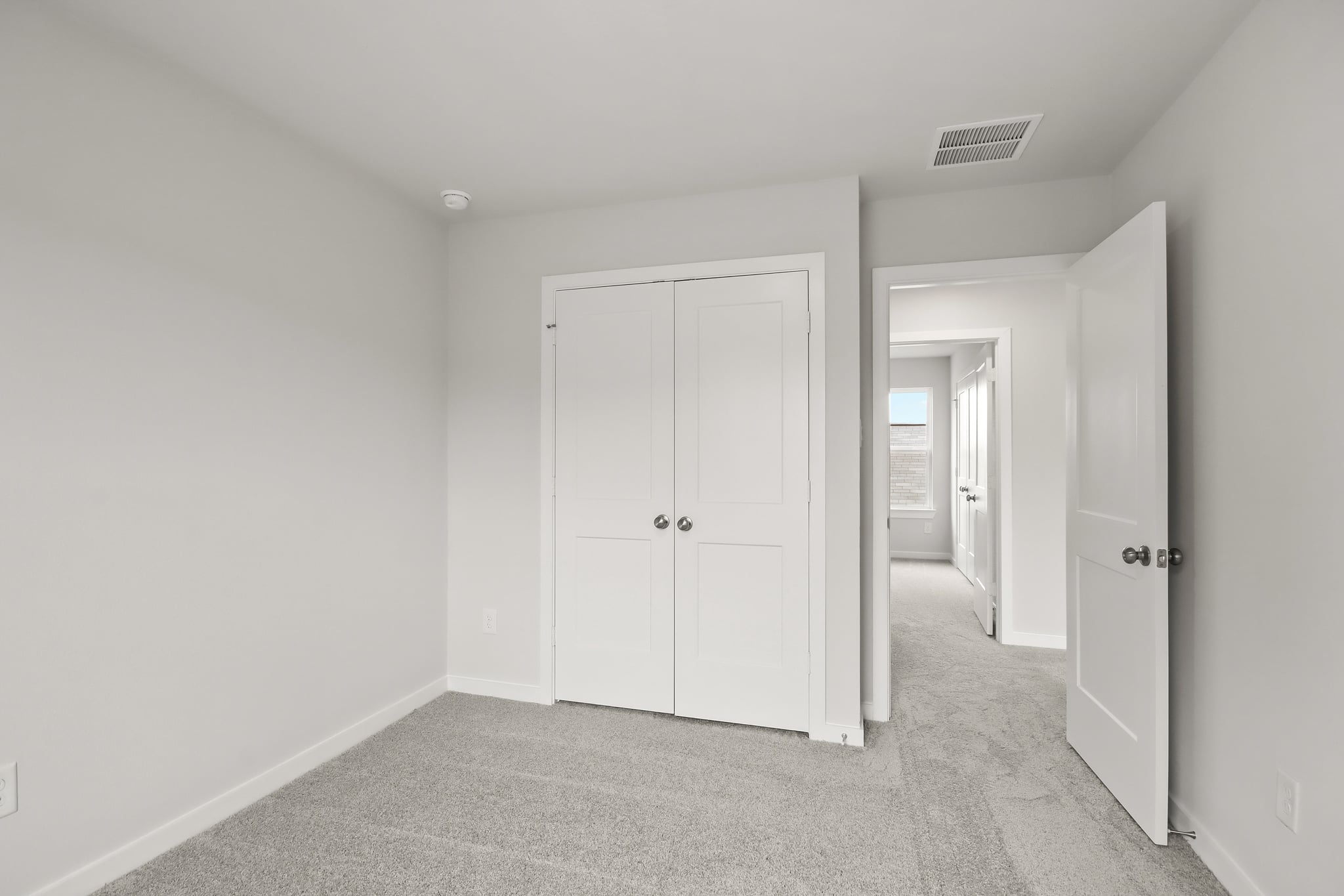 A hallway with white doors.