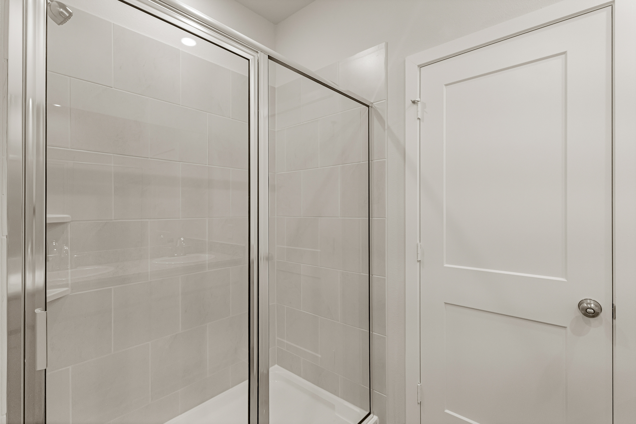 A shower with a glass door.