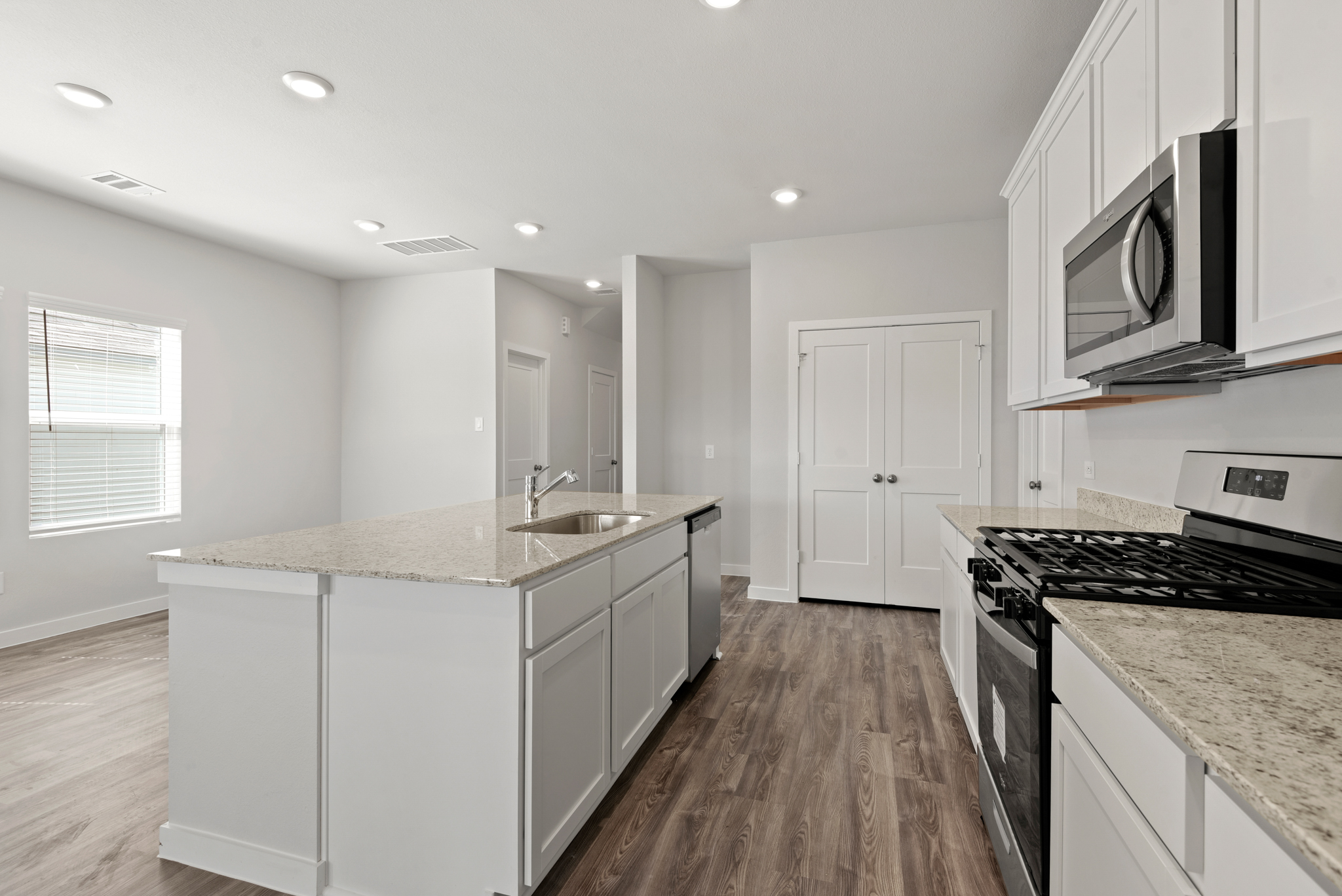 A kitchen with white cabinets.