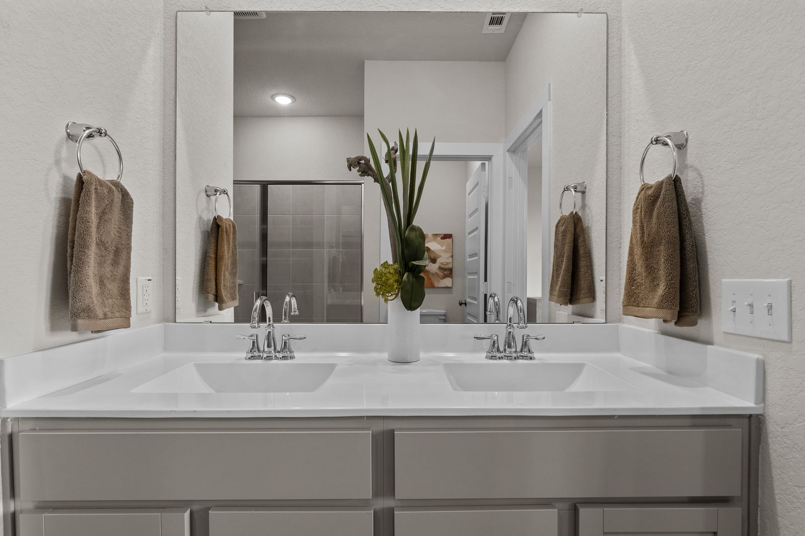 A bathroom with a large mirror.