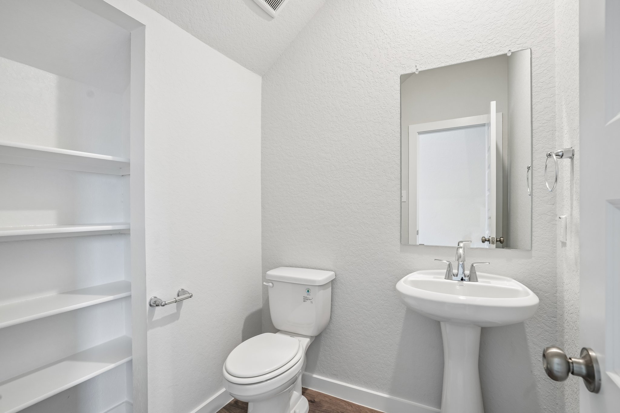 A bathroom with a toilet and sink.