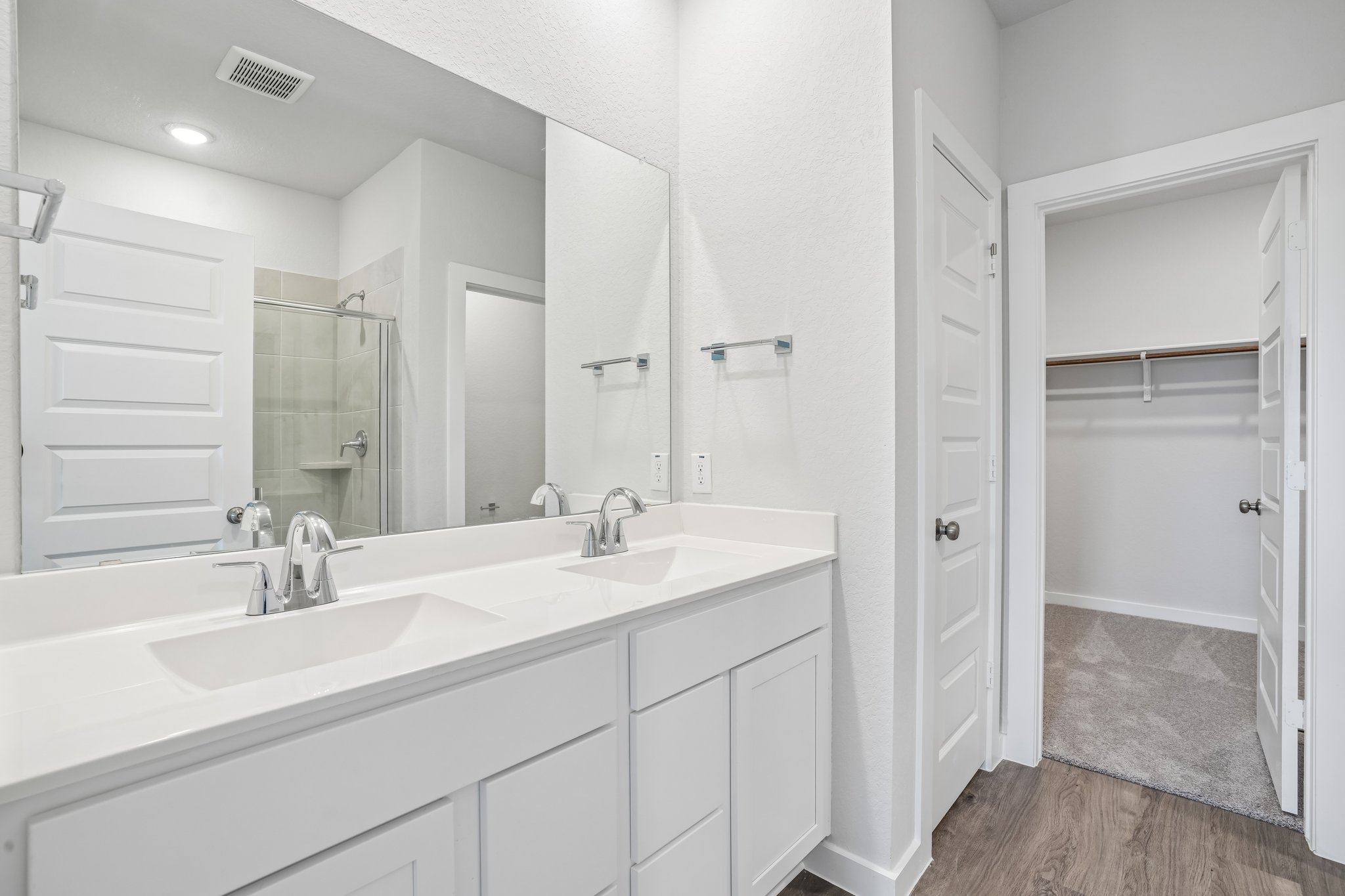 A bathroom with a sink and a shower.