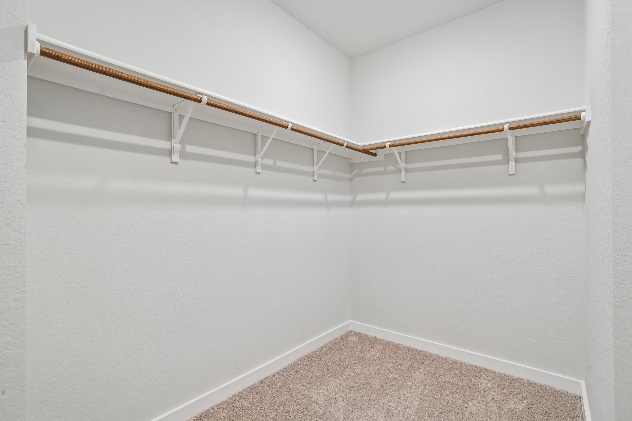 A white wall with a wooden railing.