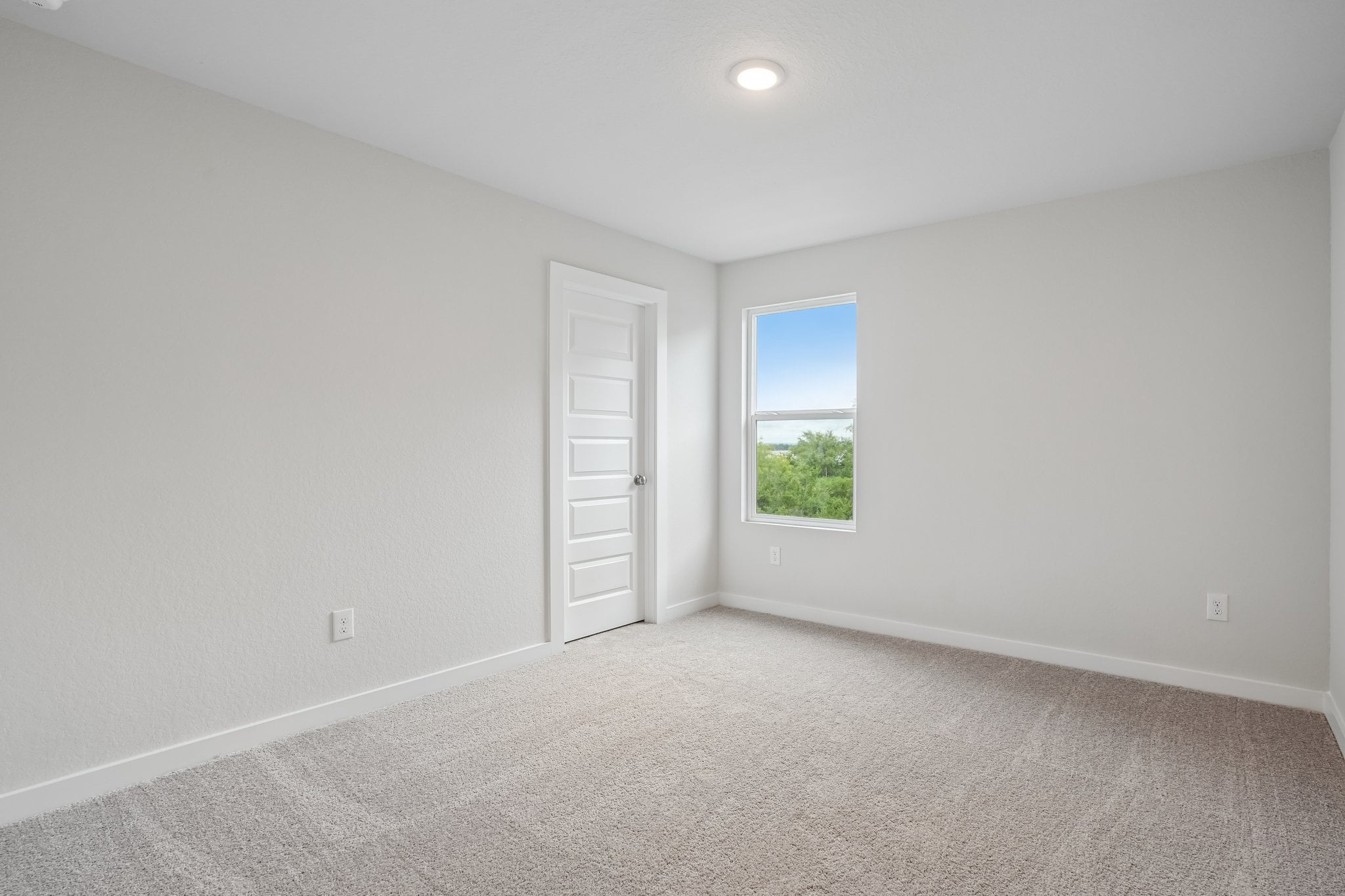 A room with a window and a door.