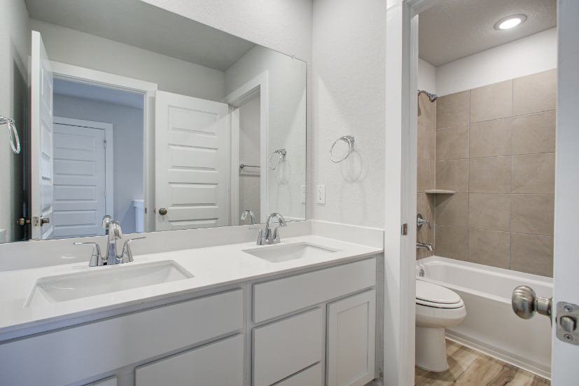 A bathroom with a sink toilet and bathtub.