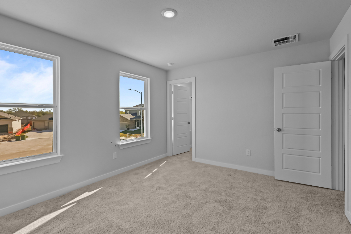 A room with white walls and a window.