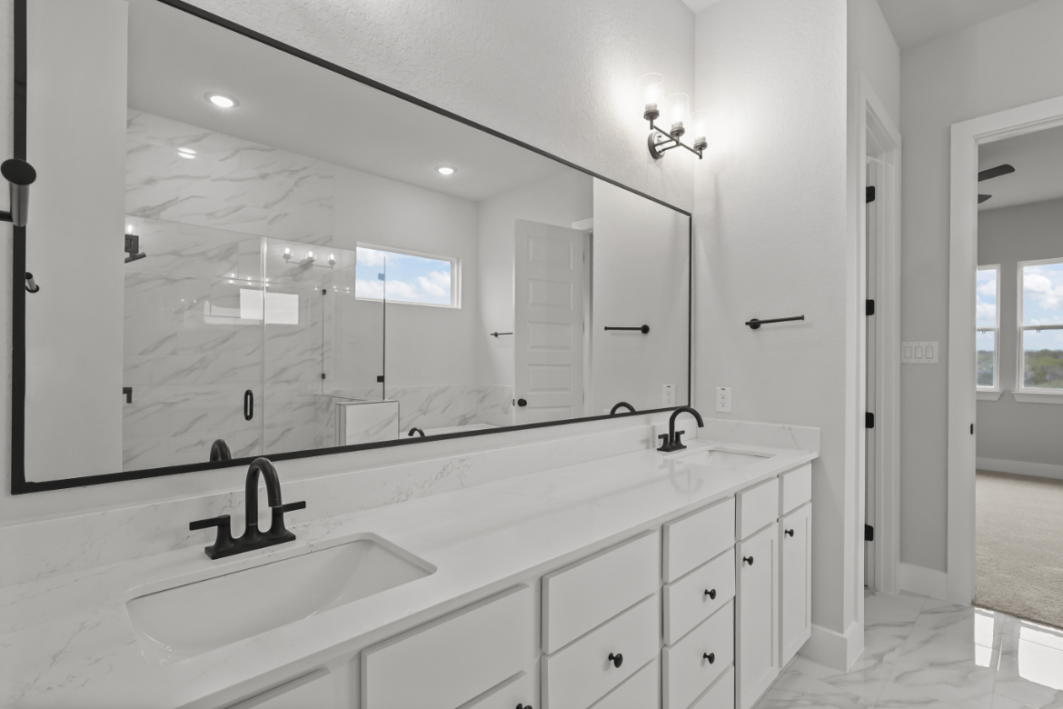 A bathroom with a large mirror.