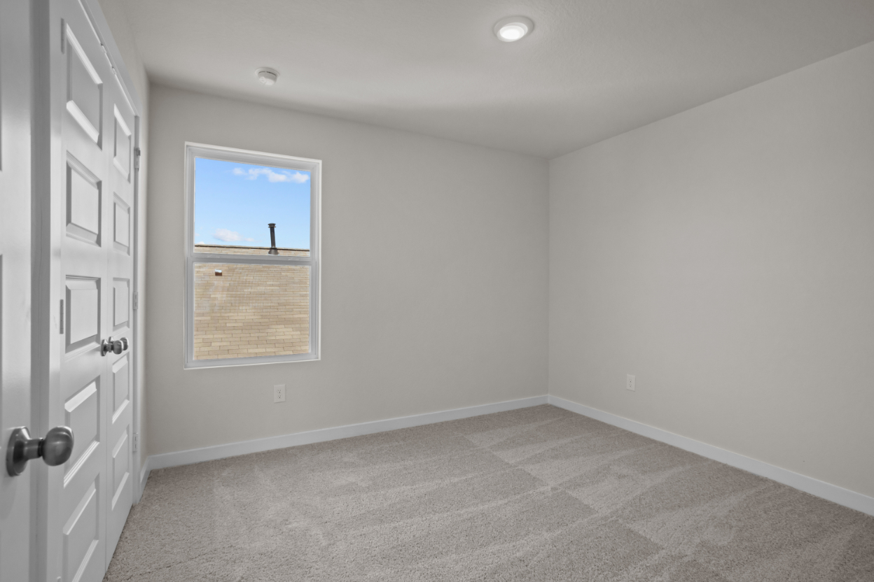 A room with a window and a door.