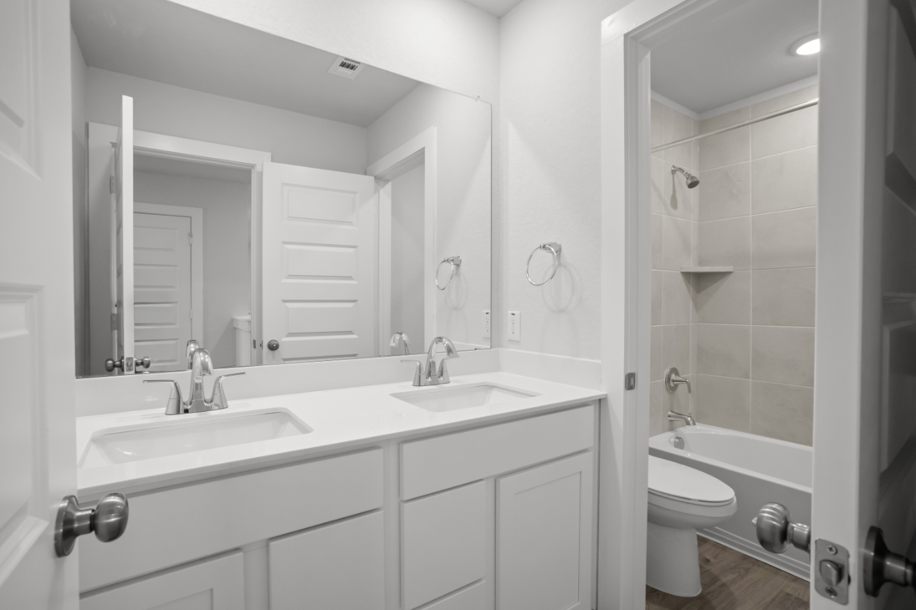 A bathroom with a sink toilet and shower.