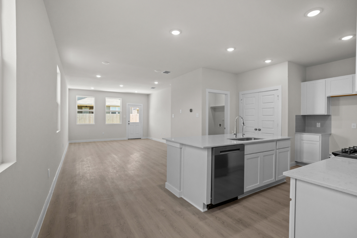A kitchen with white cabinets.