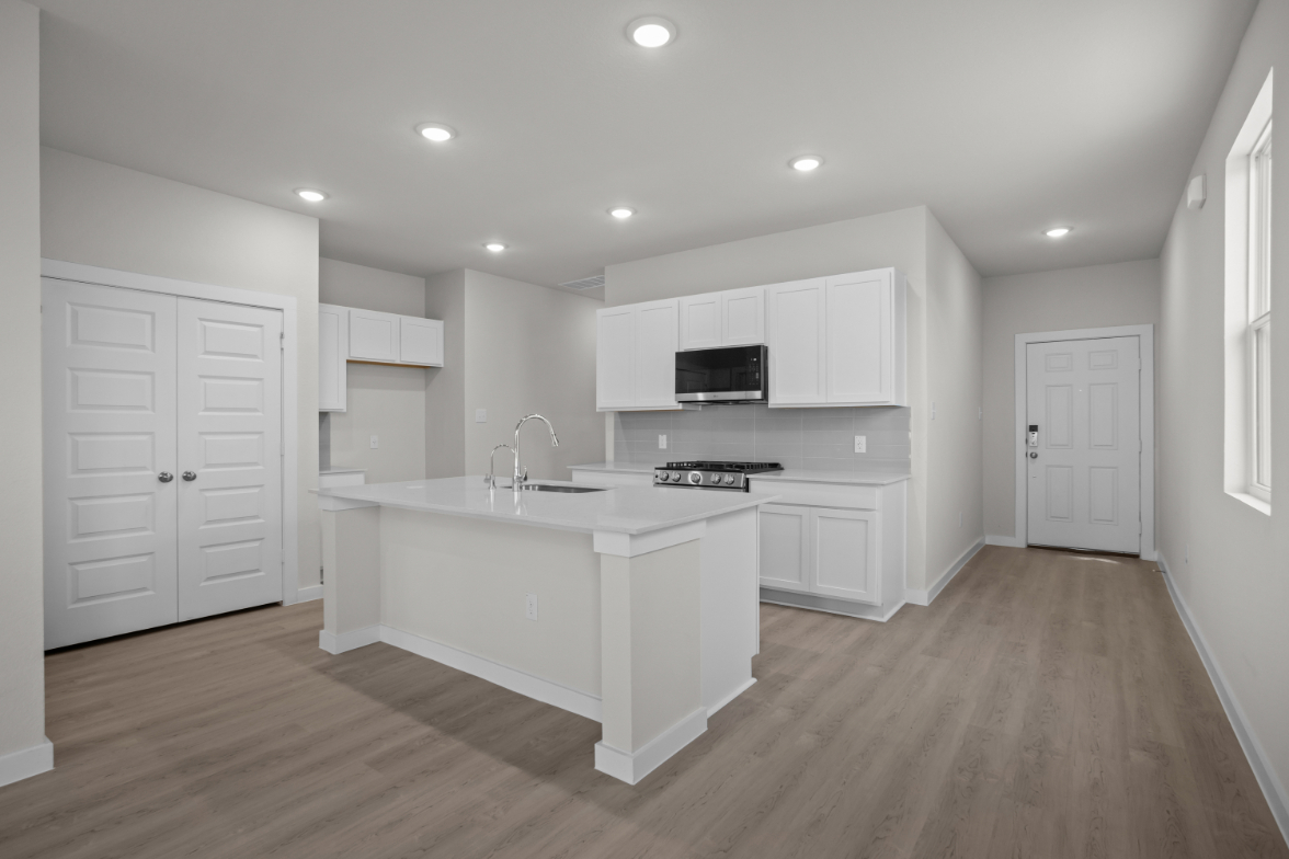 A kitchen with white cabinets.