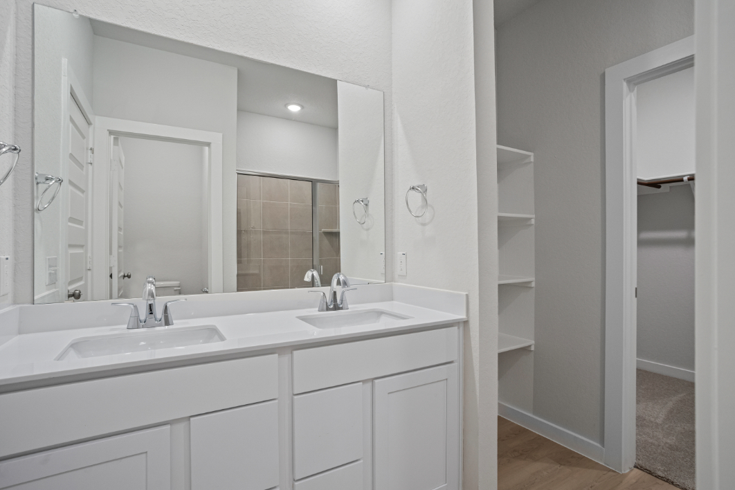 A bathroom with a large mirror.
