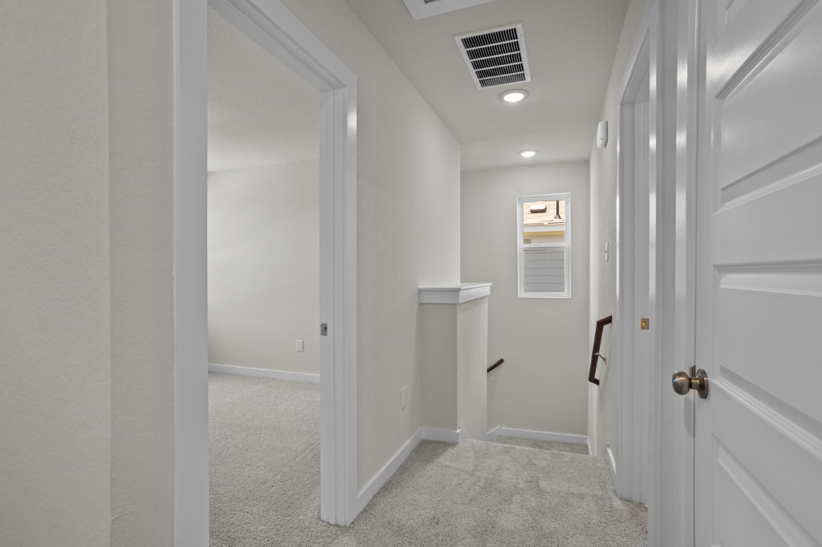 A hallway with white doors.