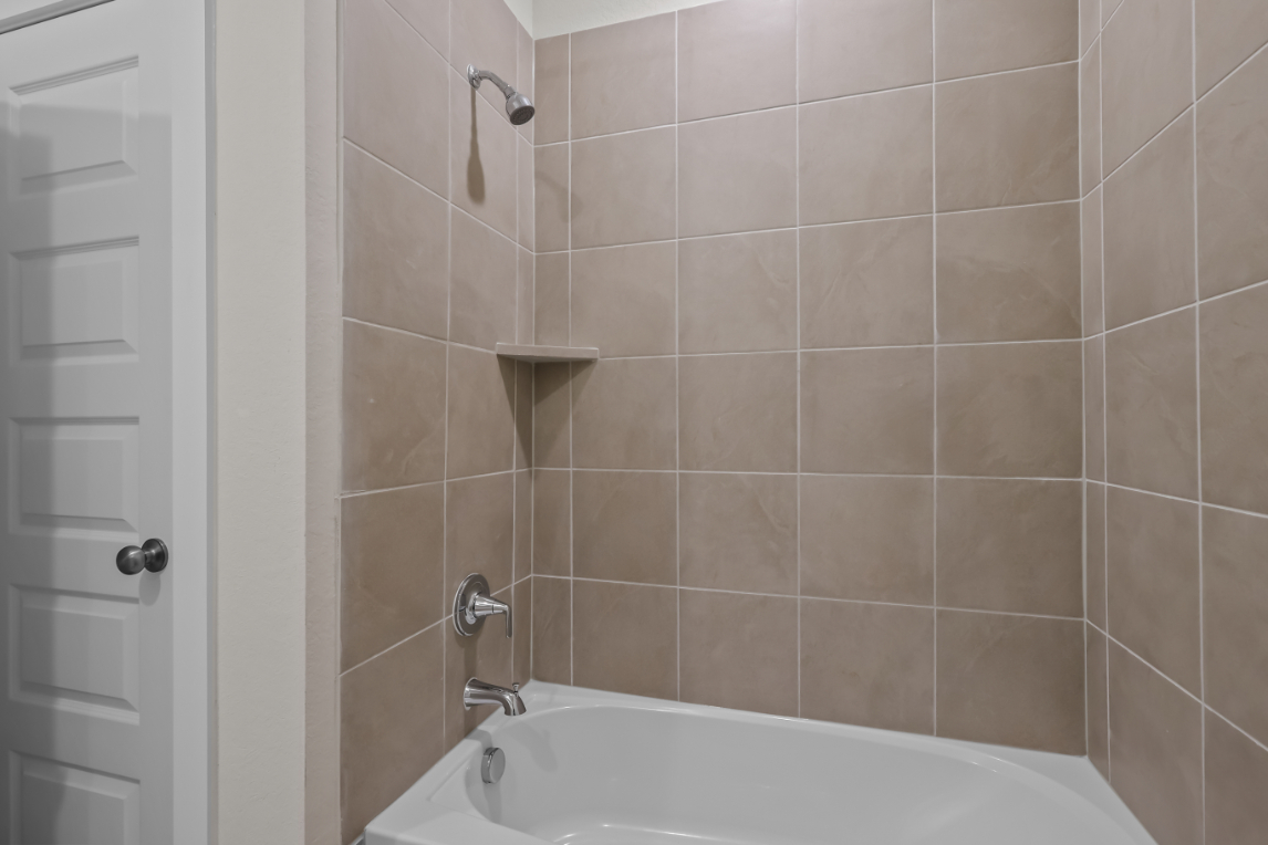 A bathtub in a bathroom.