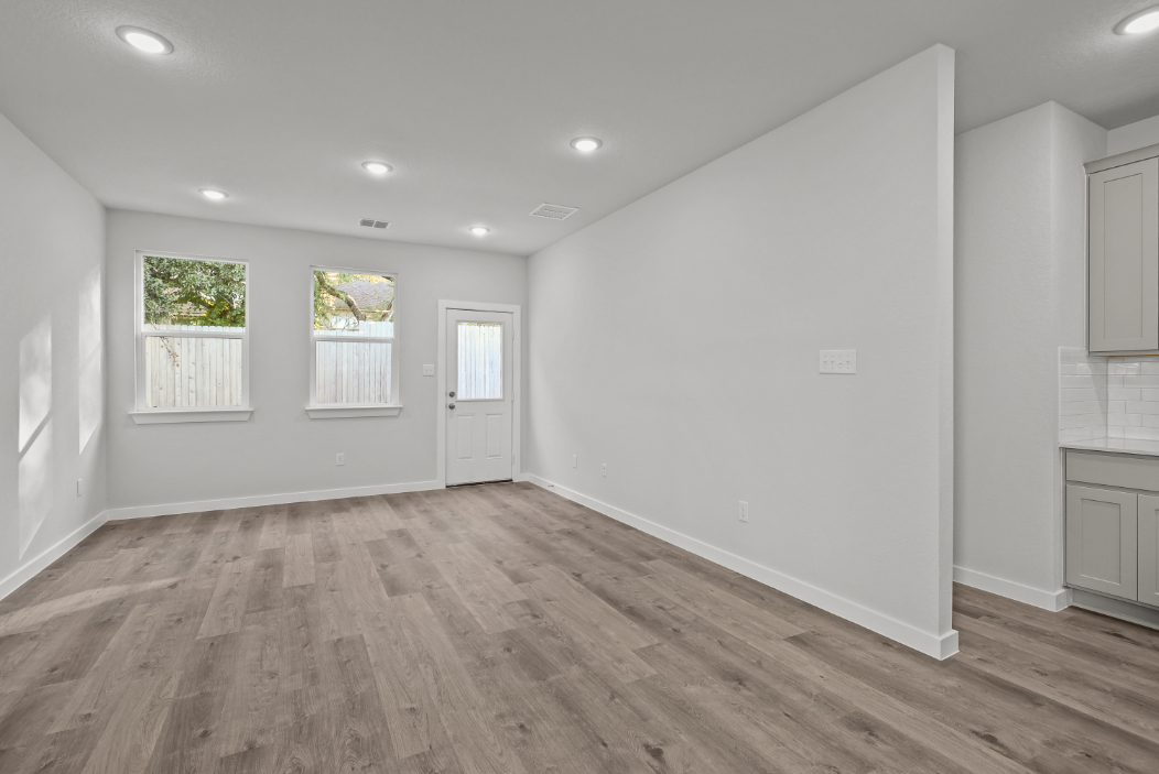 A room with white walls and a wood floor.
