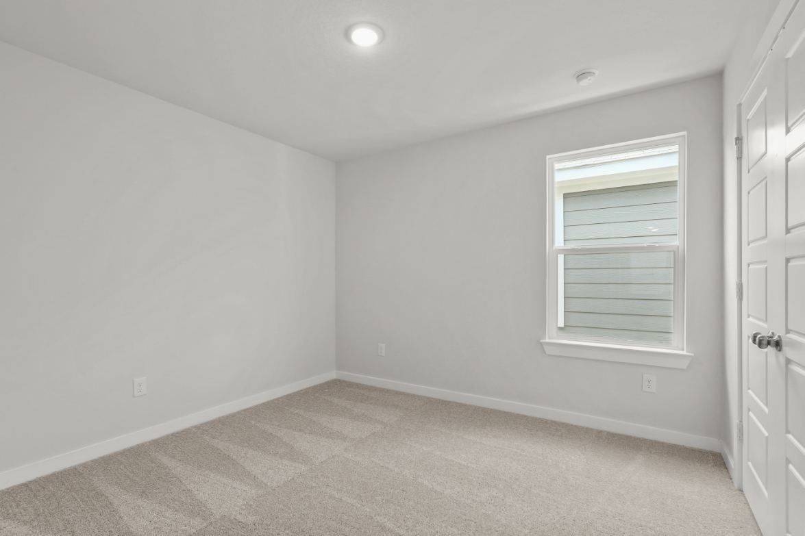 A room with a window and a door.