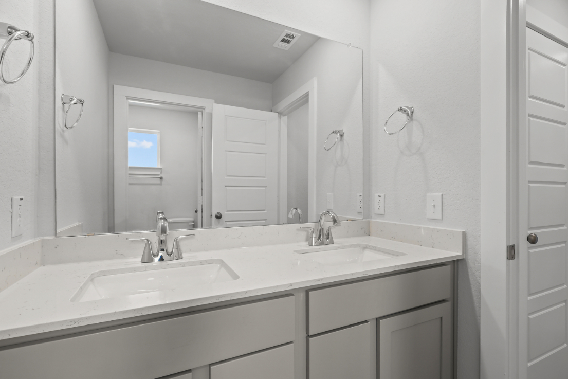 A bathroom with a large mirror.