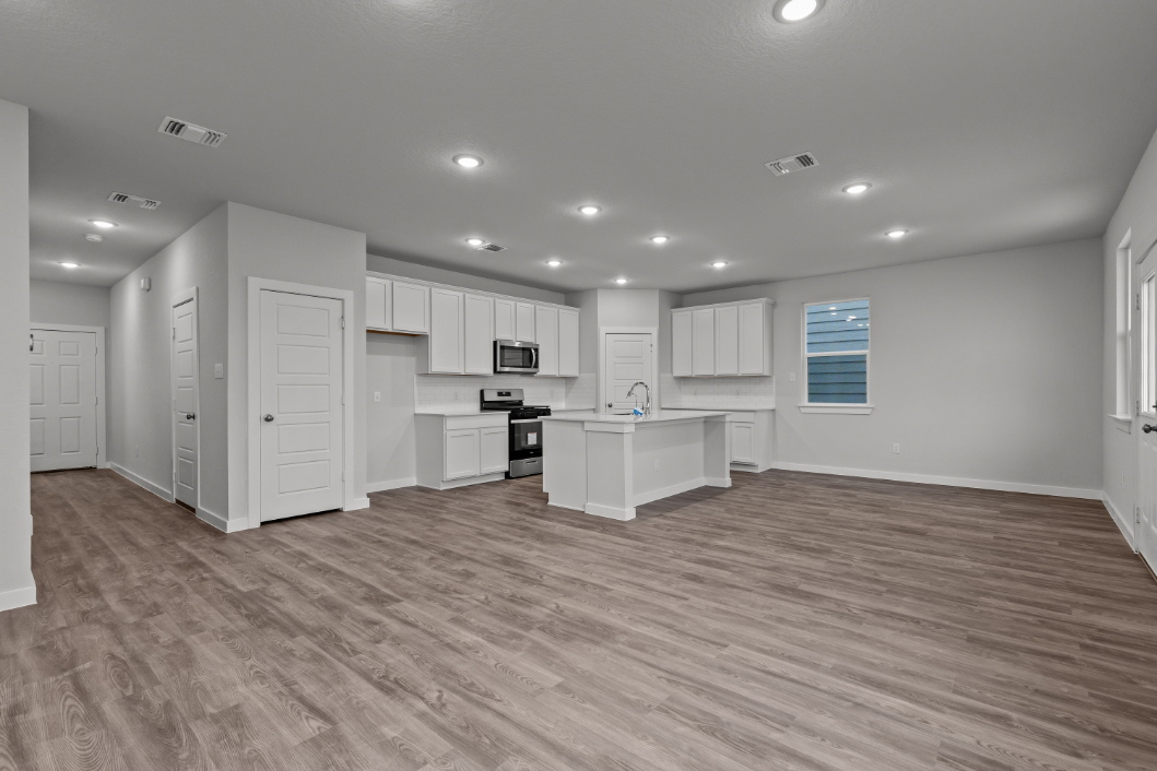 A large kitchen with white cabinets.