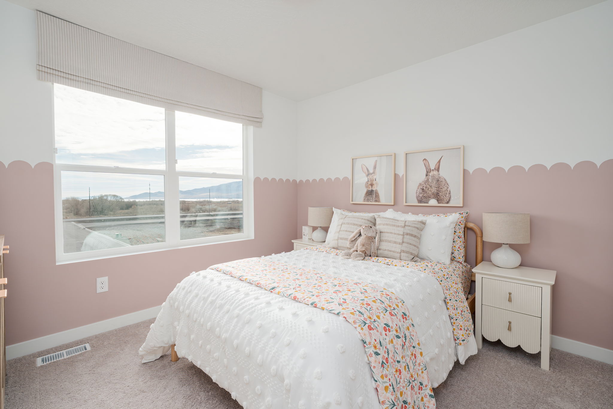 A bedroom with a large window.