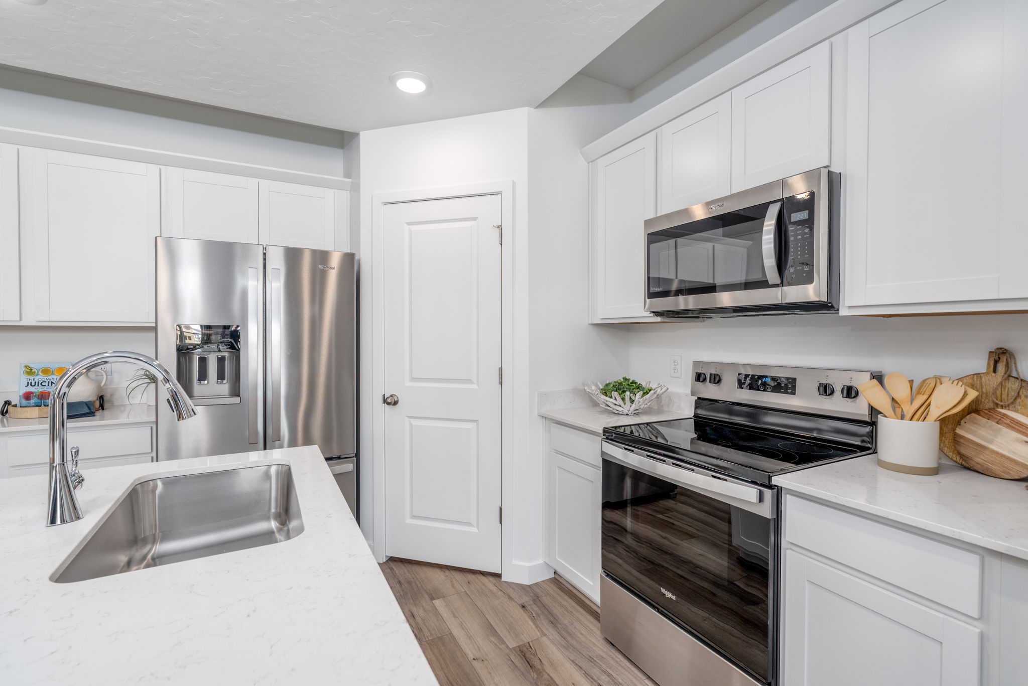 A kitchen with white cabinets.