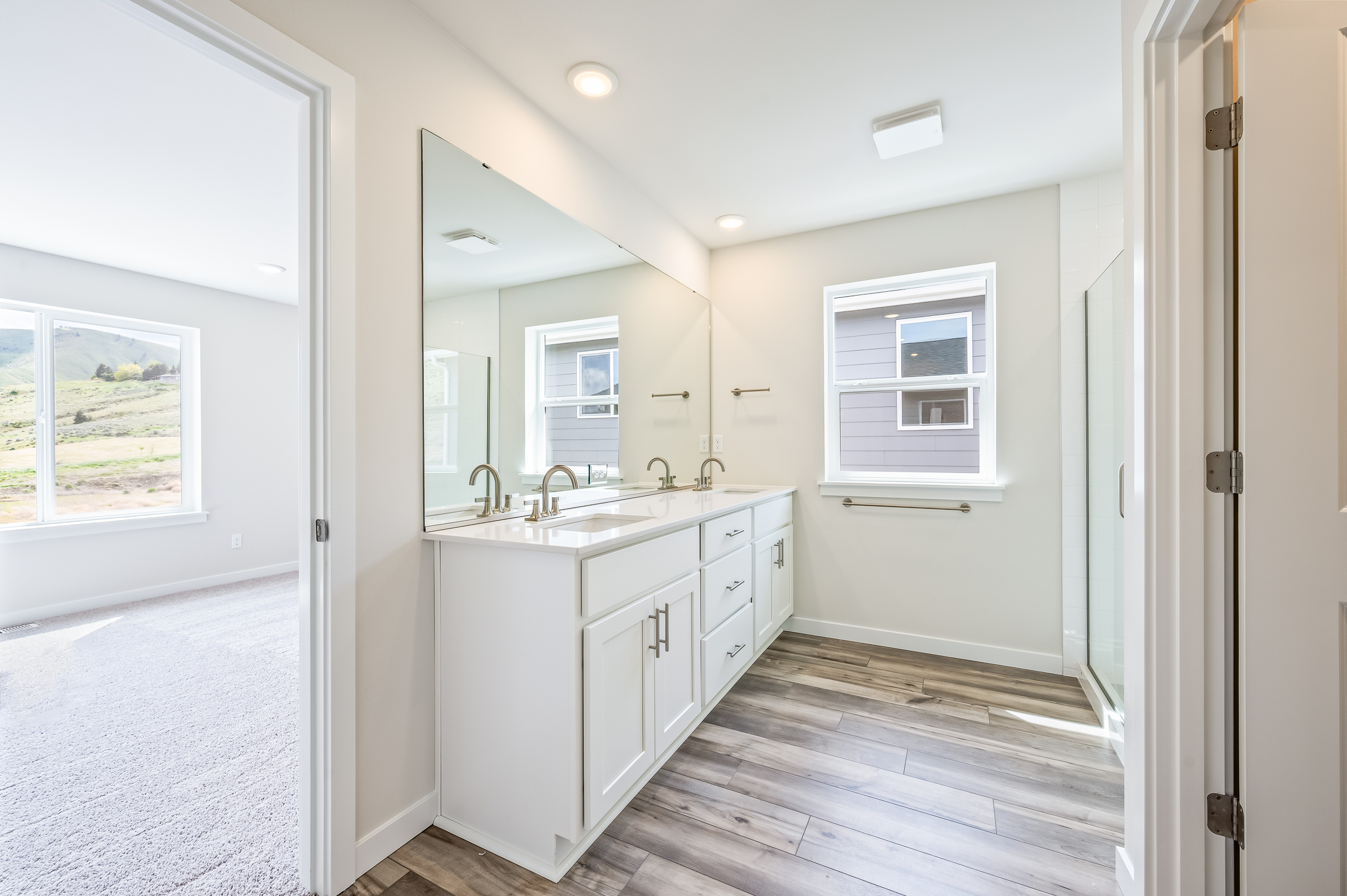 A bathroom with white cabinets.