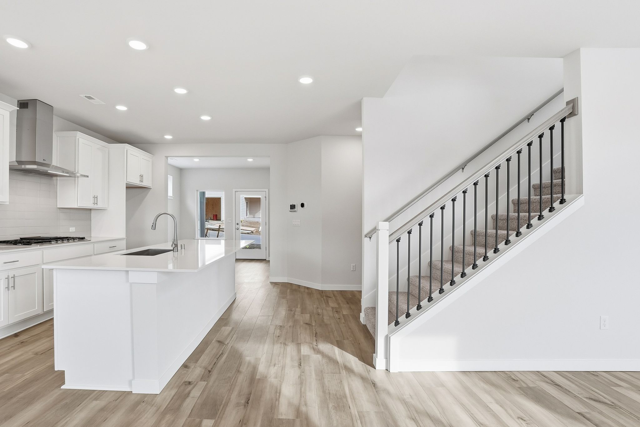 A kitchen with white cabinets.