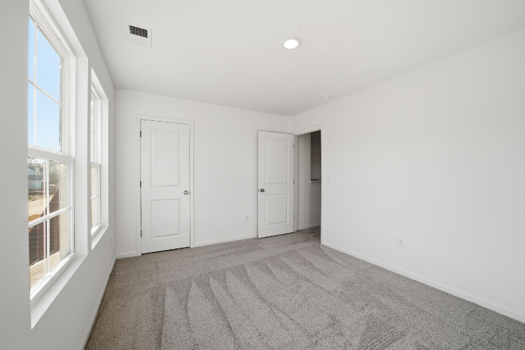 A hallway with white doors.