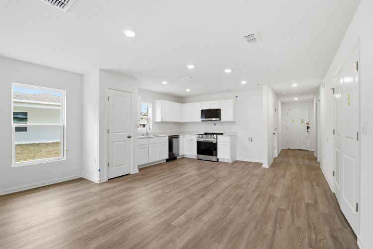 A large white kitchen with white cabinets.