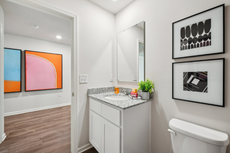 A bathroom with a sink and a mirror.