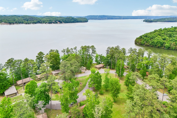 A body of water with trees and buildings around it.