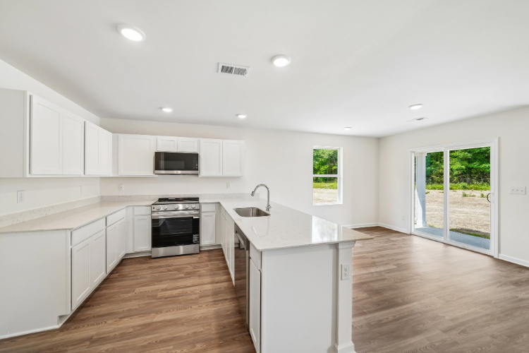 A kitchen with white cabinets.