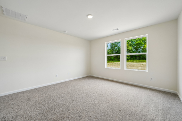 A room with a window and a carpet.
