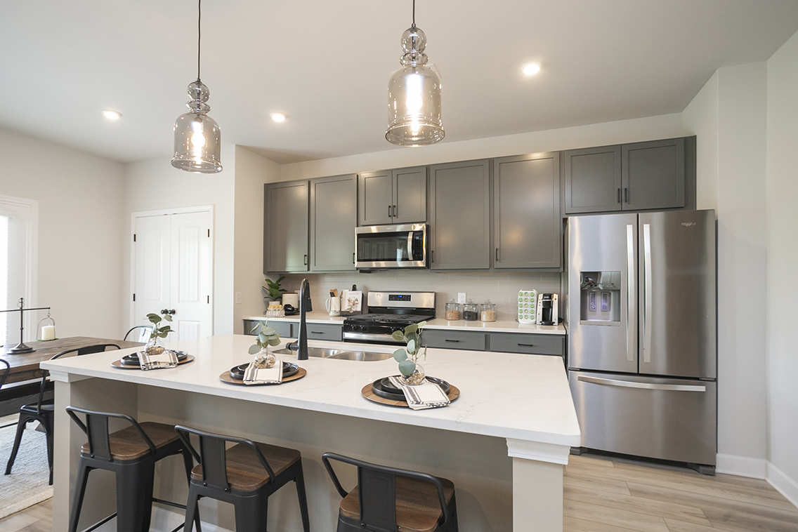 A kitchen with a table and chairs.