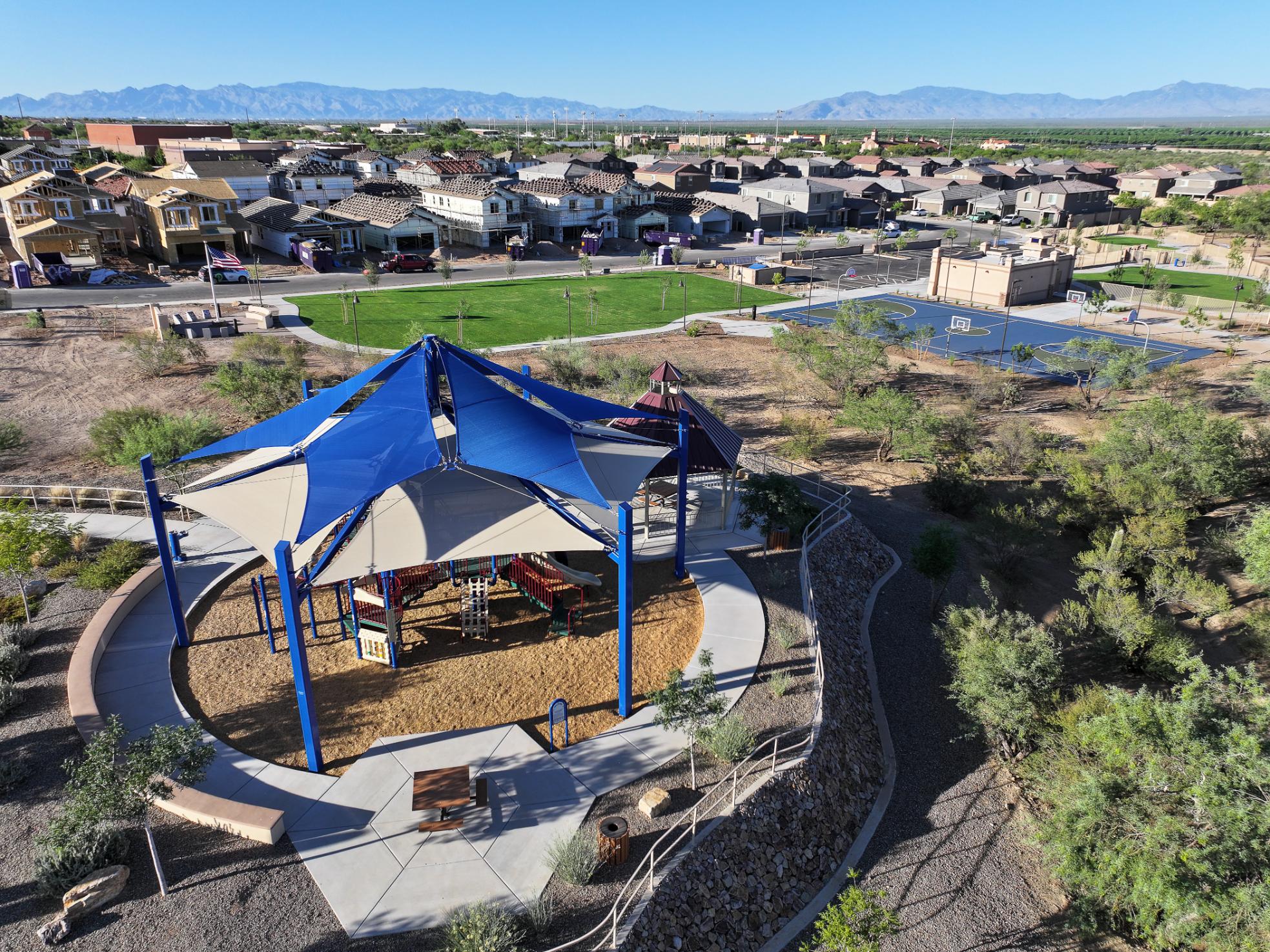 A small building with a pool in the middle of a town.