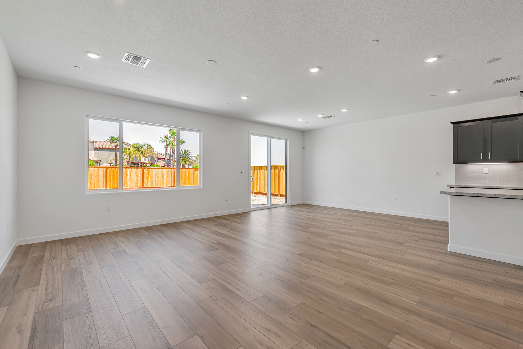A room with a wood floor and a large window.